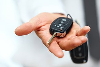 Expert locksmith handing replacement car keys